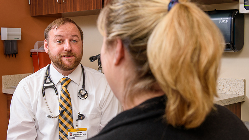 Luke Stephens, MD, visits with a patient at MU Health Care’s family medicine clinic in Ashland.
