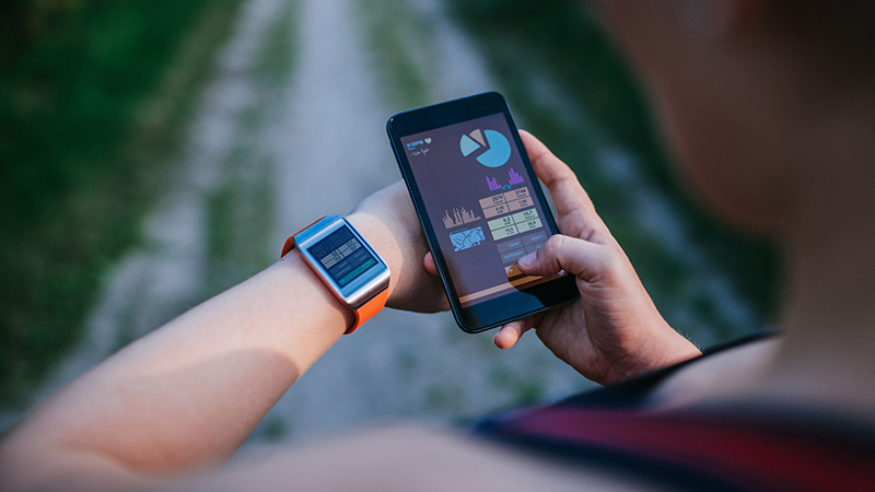 woman synchronizing smartwatch