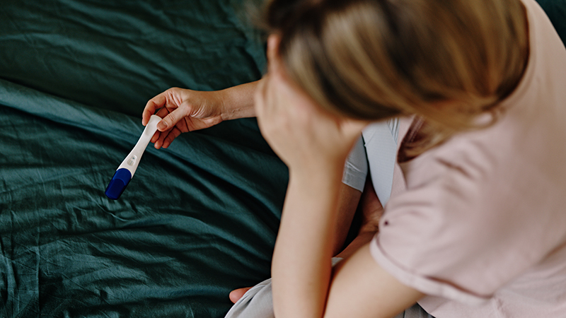 woman with a pregnancy test