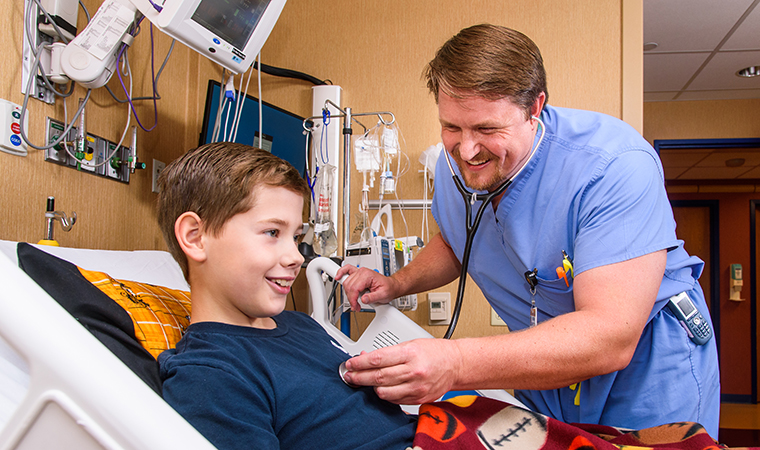  Dr. Nathan Beckett with pediatric patient