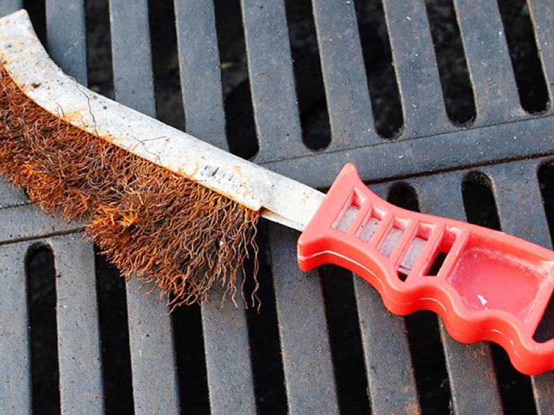 grill brush laying on bbq