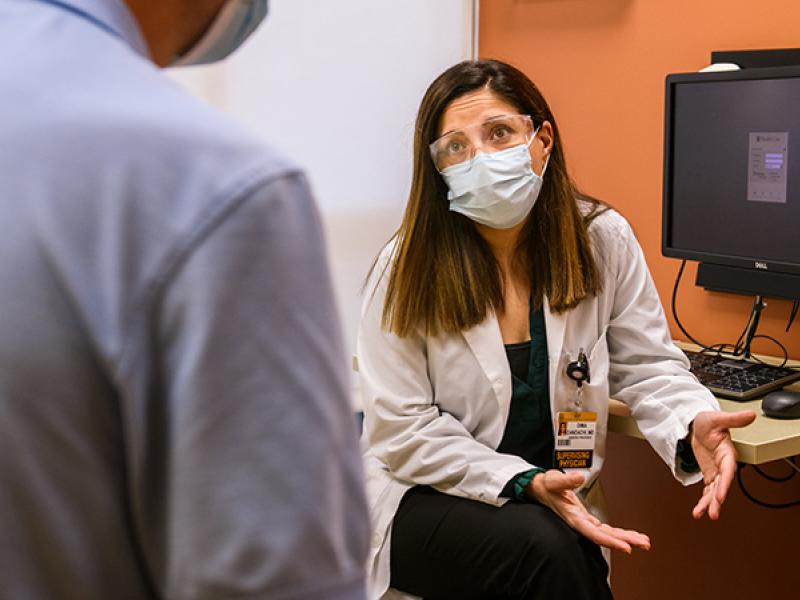 Dr. Dima Dandachi, MD talks with a patient.