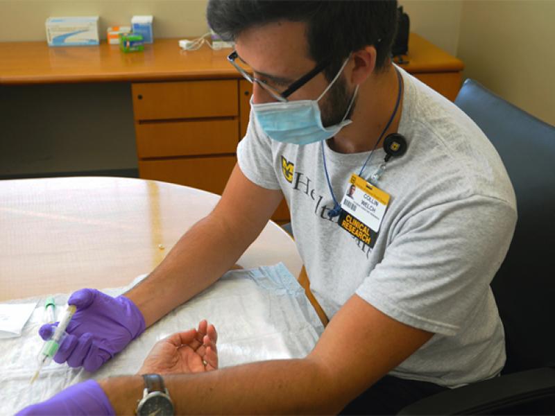 A member of the research team draws a blood sample from a participant.