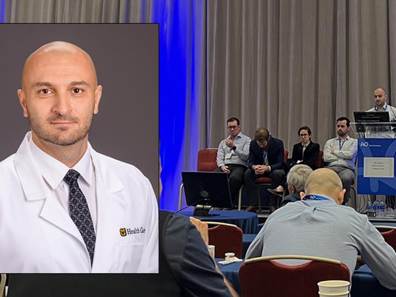 Dr. Zourabian presenting poster to forum attendees