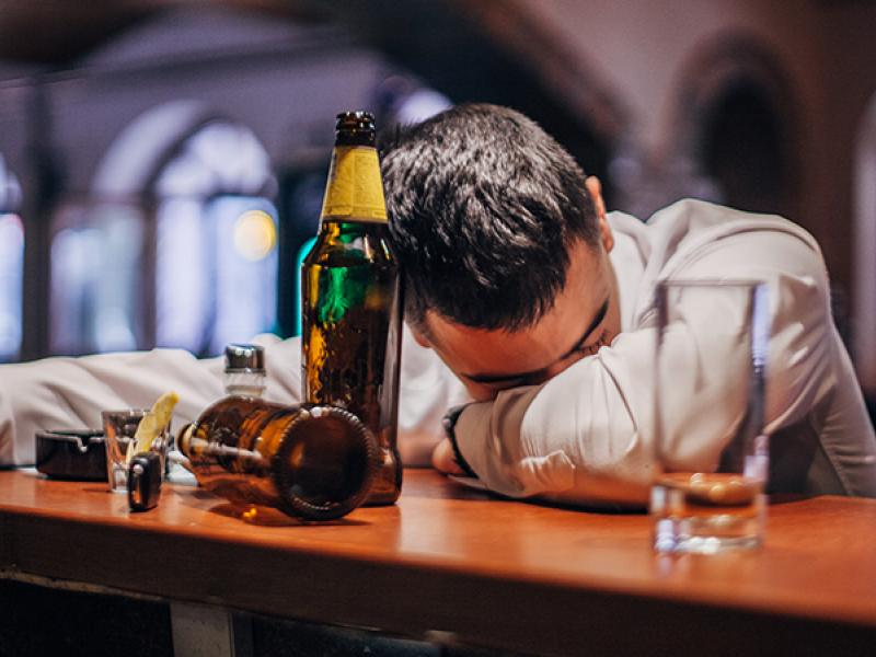 man asleep at a bar
